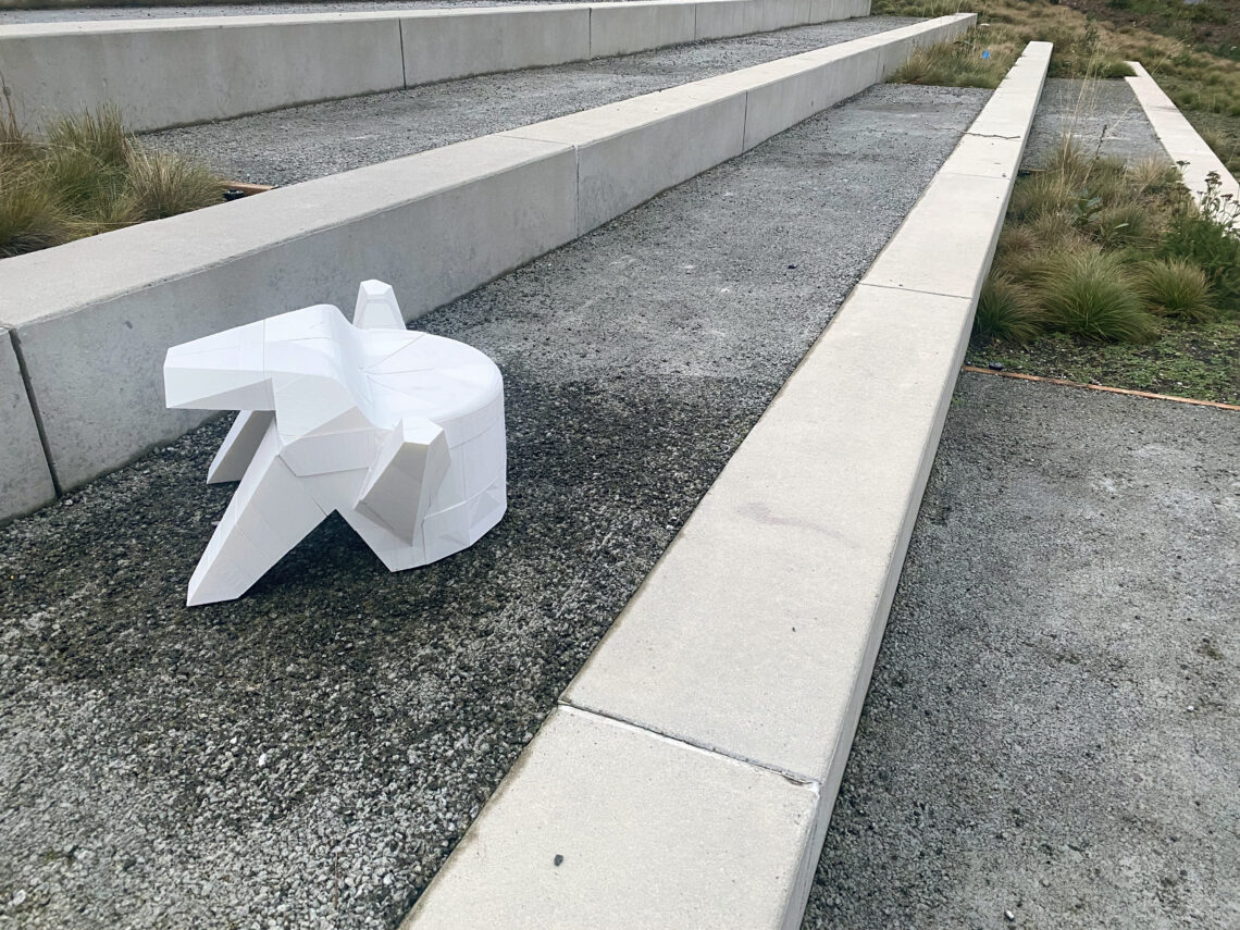 3D printed white chair sitting on concrete steps