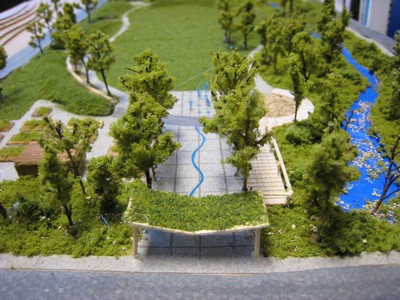Model of open space with trees, grass and water feature