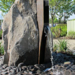 Water flowing out of rock sculpture