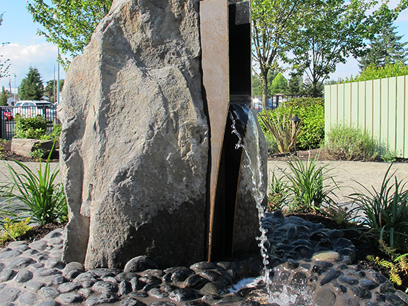 Water flowing out of rock sculpture