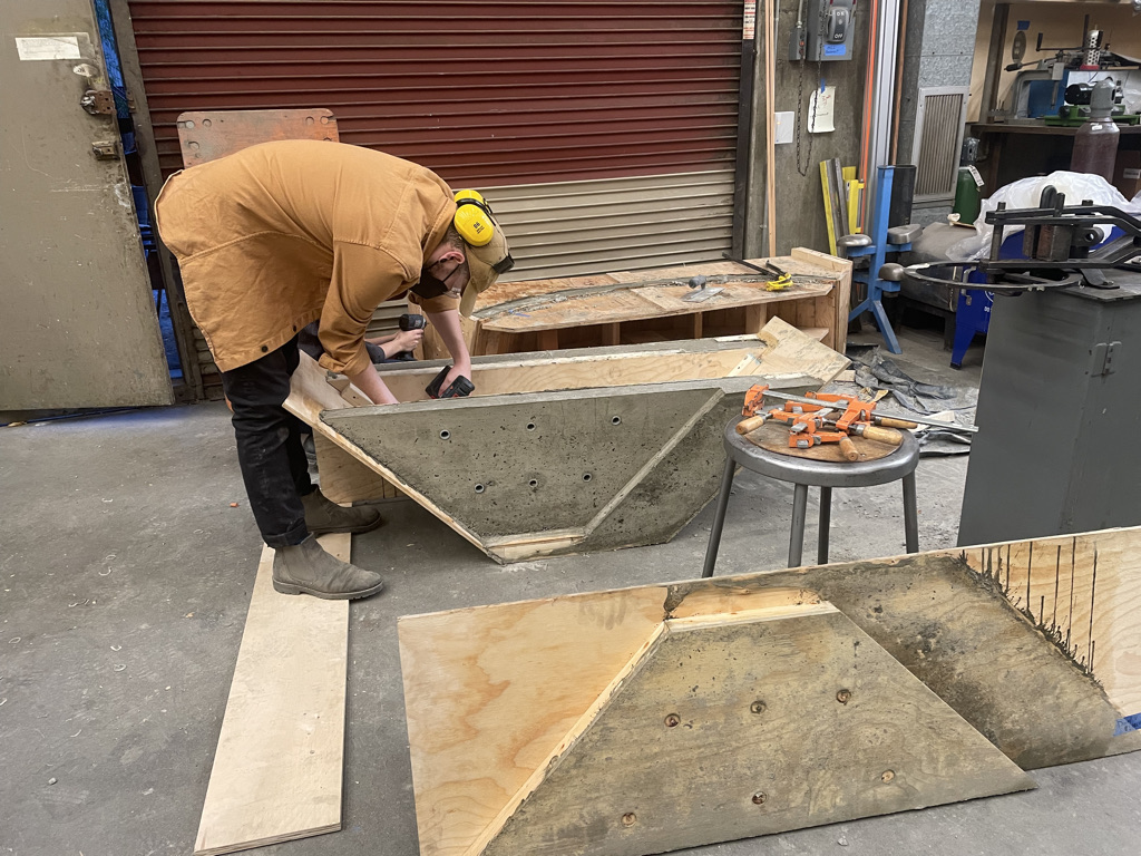 Student working on a piece of concrete